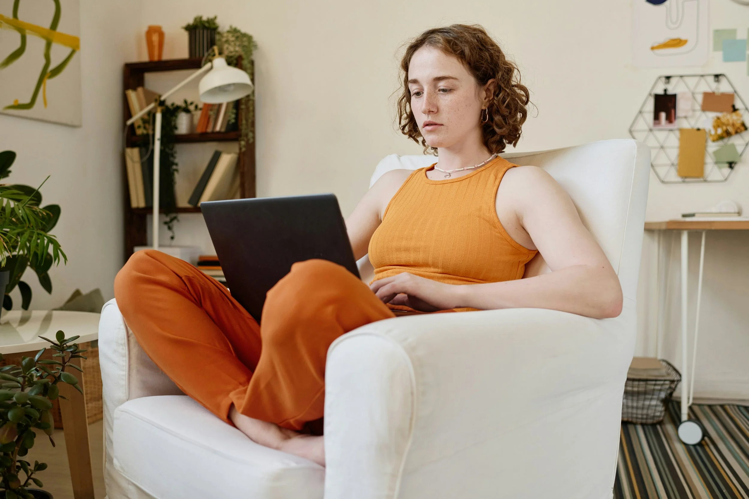 Woman in online therapy session with laptop